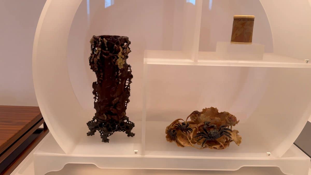 A carved root-wood brush pot on a stand