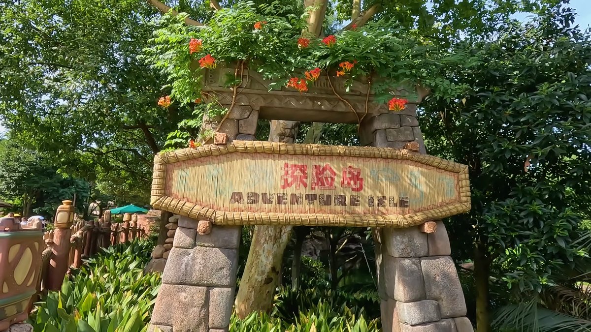 A carved stone archway with a sign among