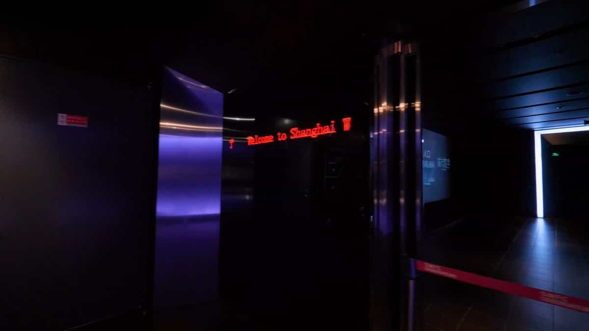 A dark corridor with a red LED ticker