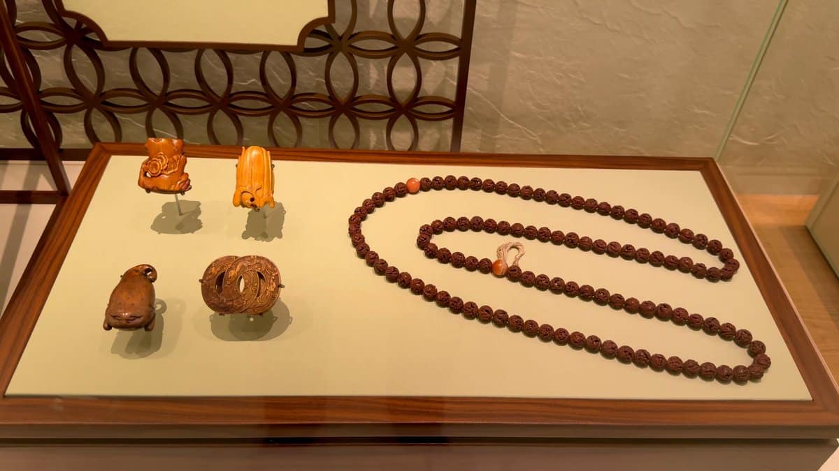 A long string of beads and carved seeds