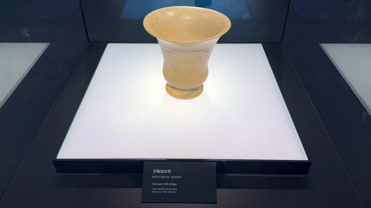 A pale glazed vessel with a flared mouth