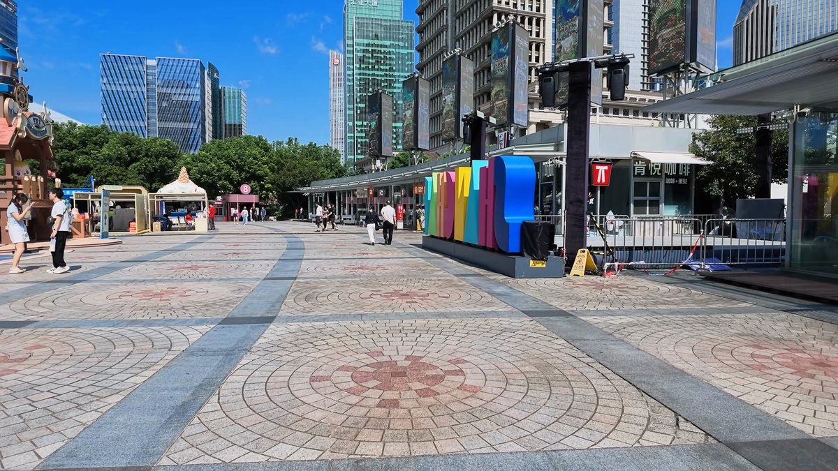 A paved plaza with a patterned floor, colourful