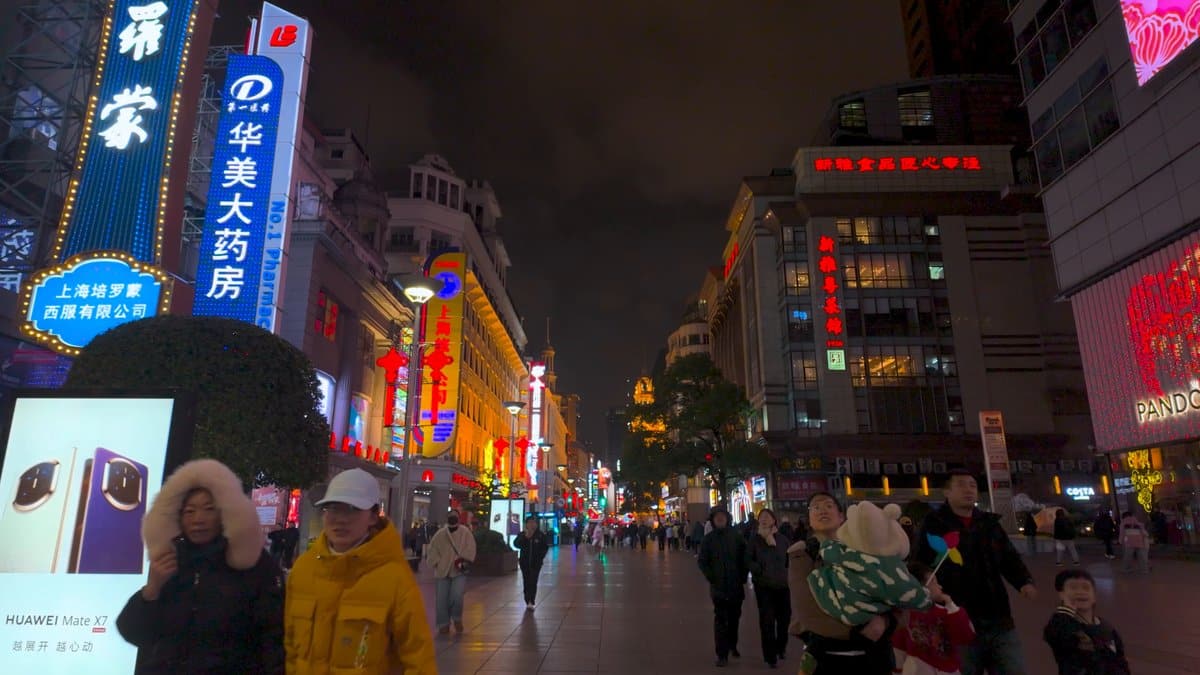 A 华美大药房 pharmacy sign lit in blue at