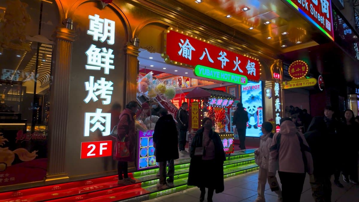 A restaurant entrance with a tall 朝鲜烤肉 2F