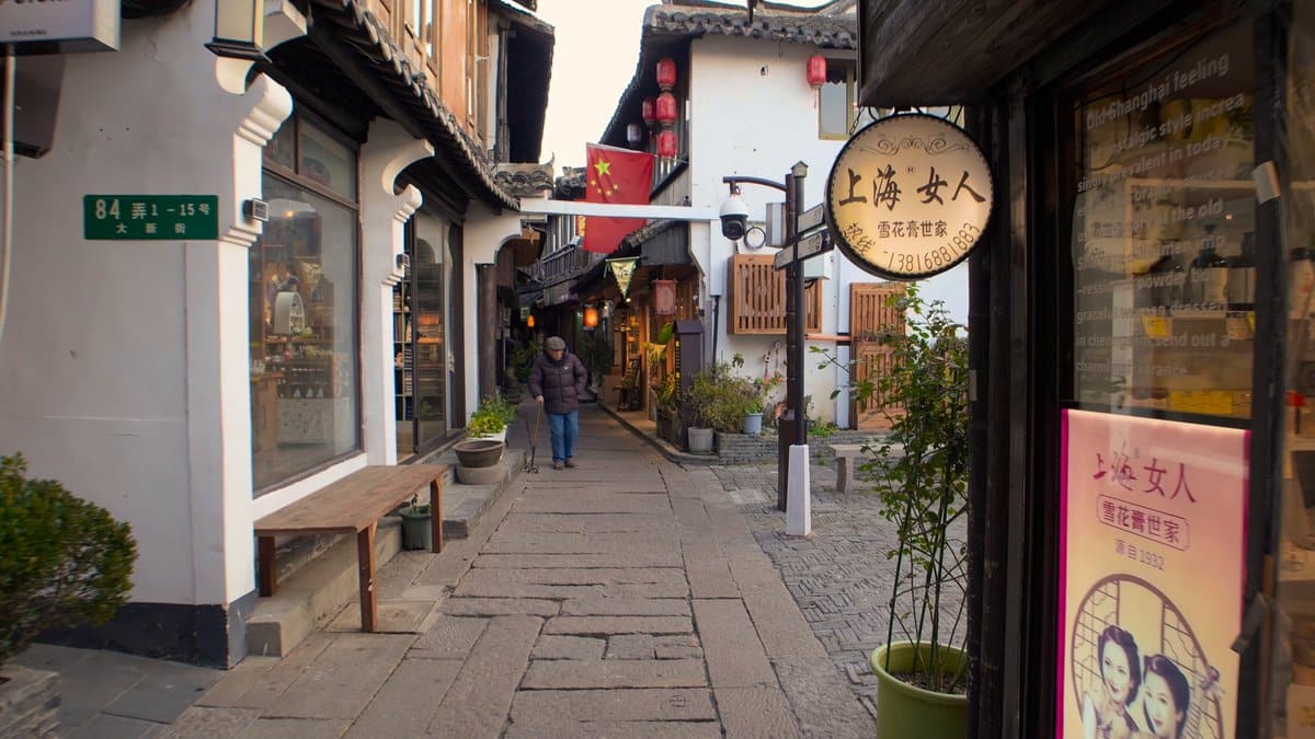 A round hanging sign reading 上海女人 雪花膏世家 for