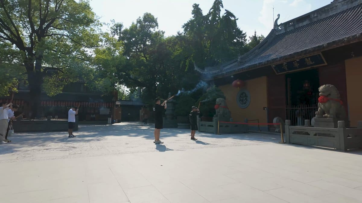 A shaded courtyard with a hall's roof showing