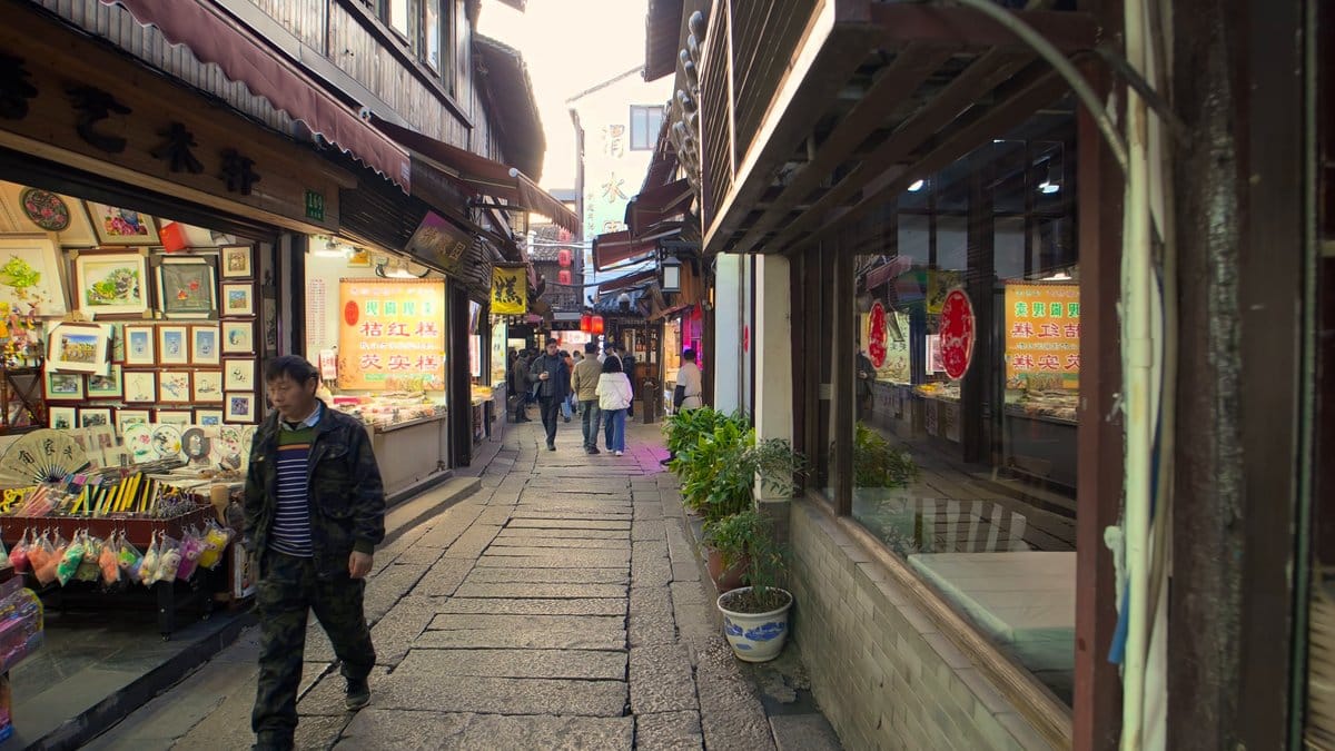 A shop hung with framed prints and paintings,