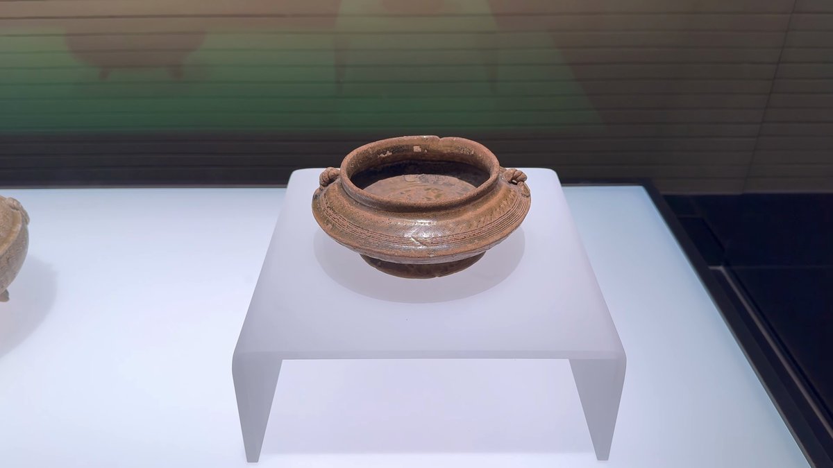 A simple pottery bowl with loop handles on