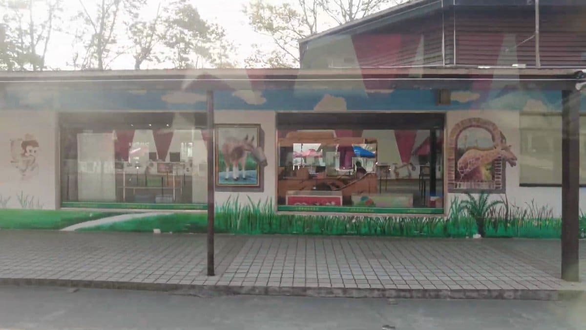 A single-storey building painted along its front with
