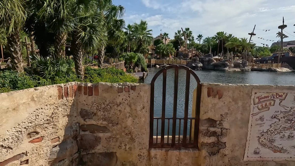 A stone wall with an arched iron gate