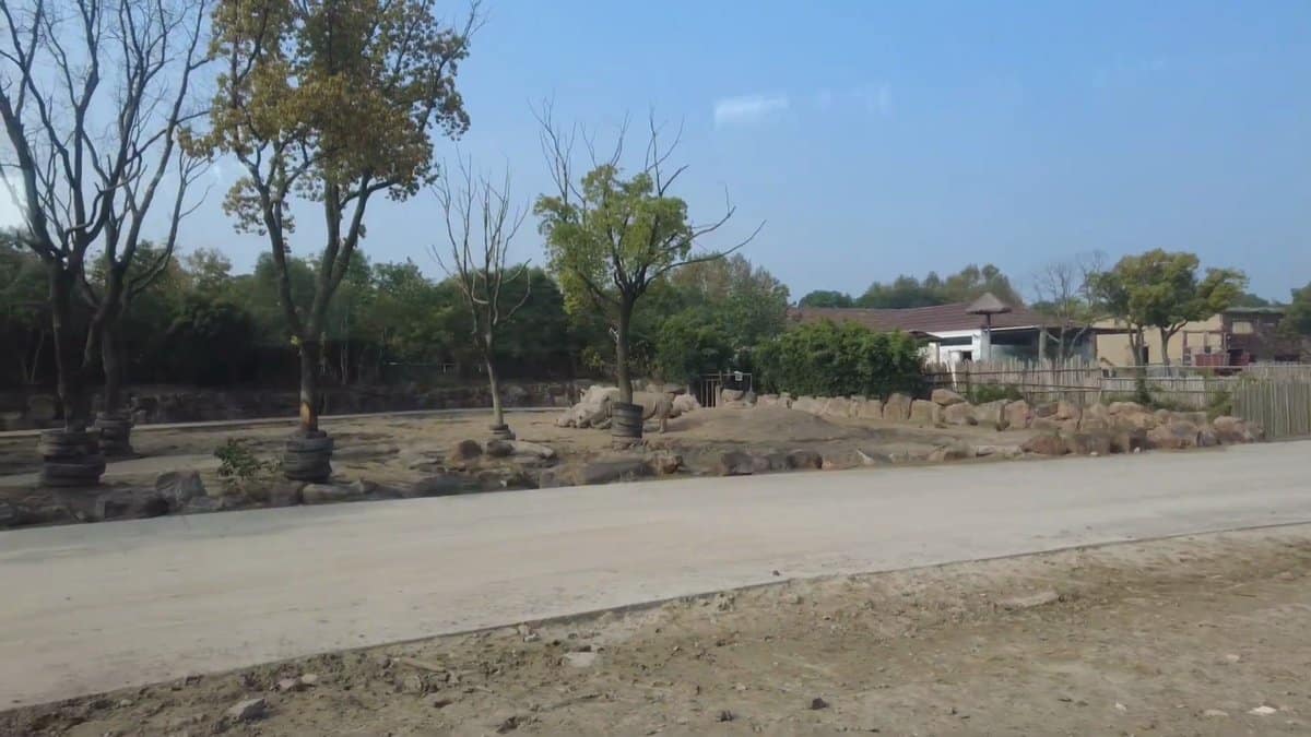 An open dusty plain with a low building