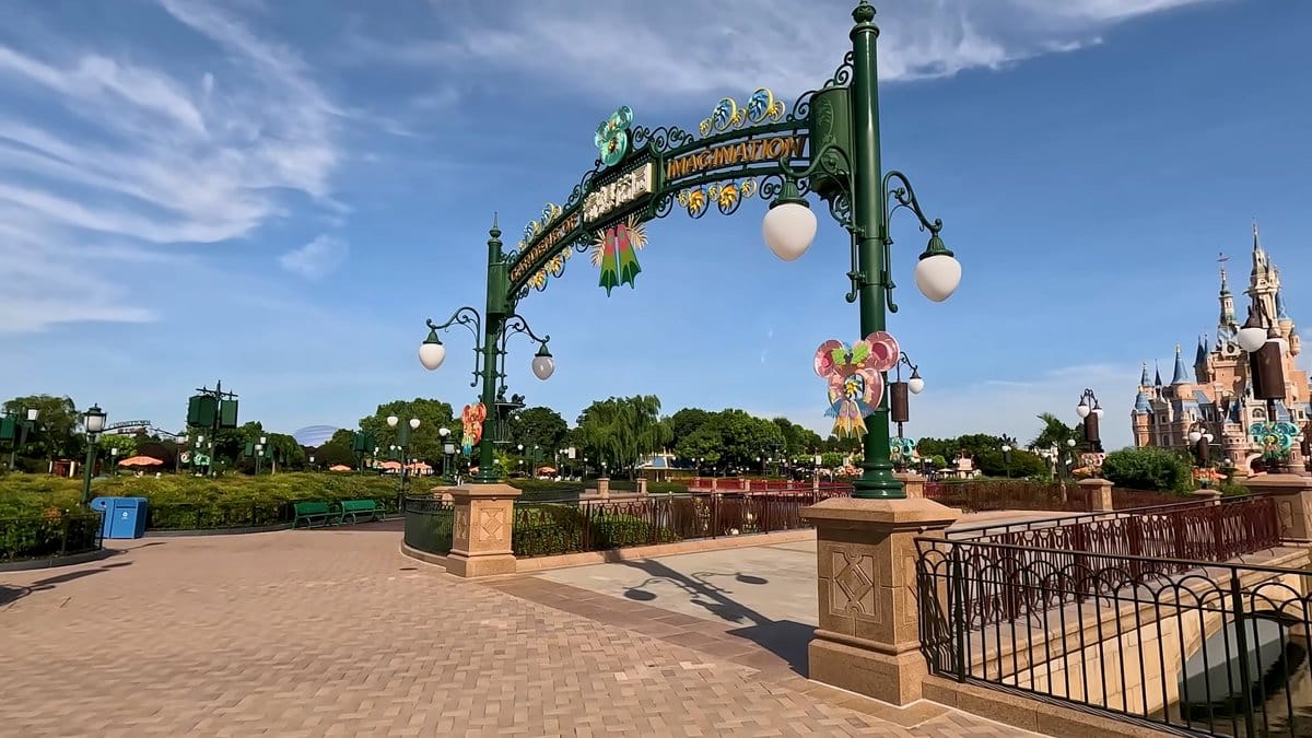 An ornamental iron arch with lamps over a