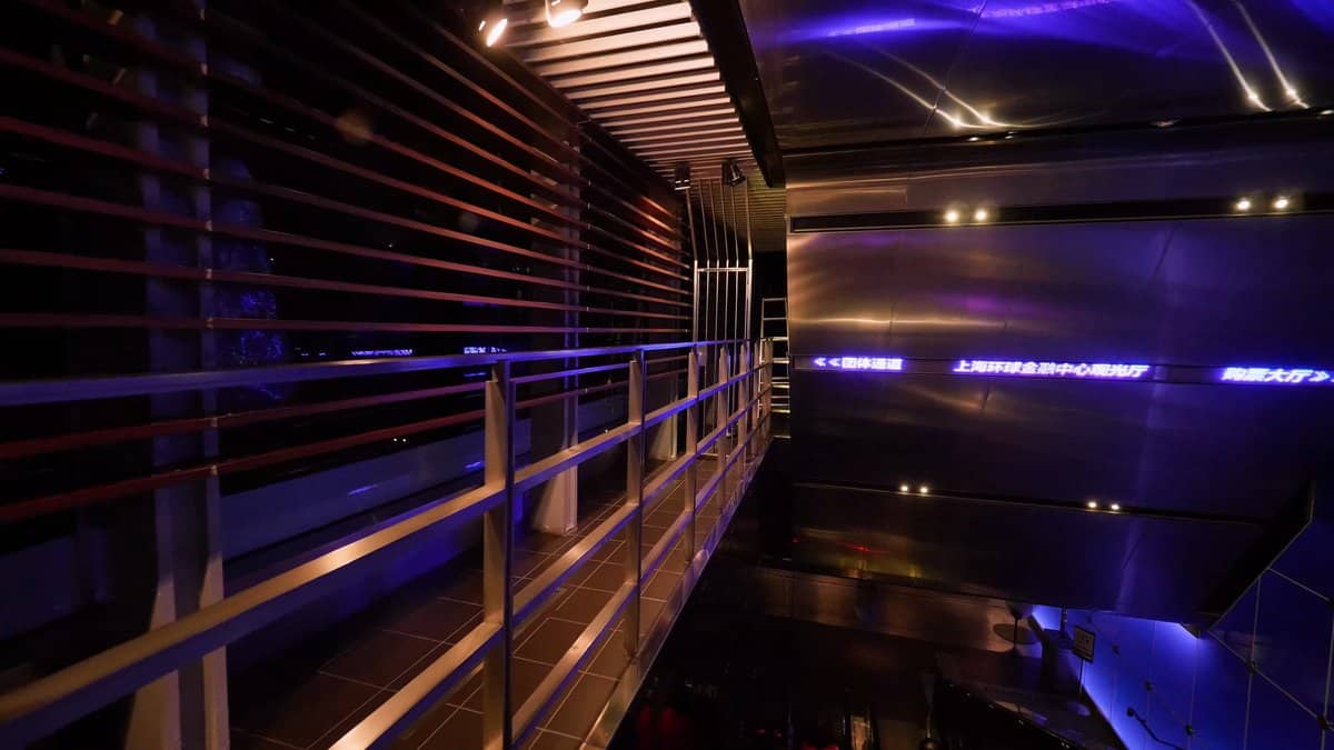Blue-lit walkway into the tower