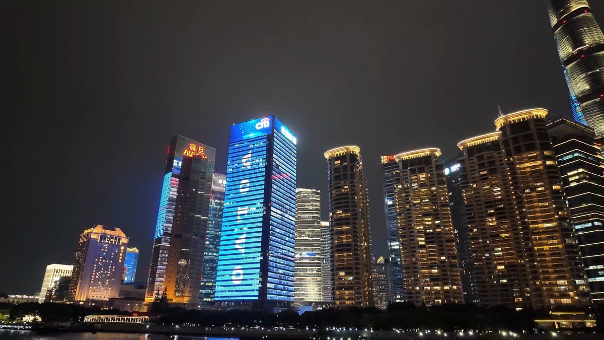Blue-lit waterfront towers at night