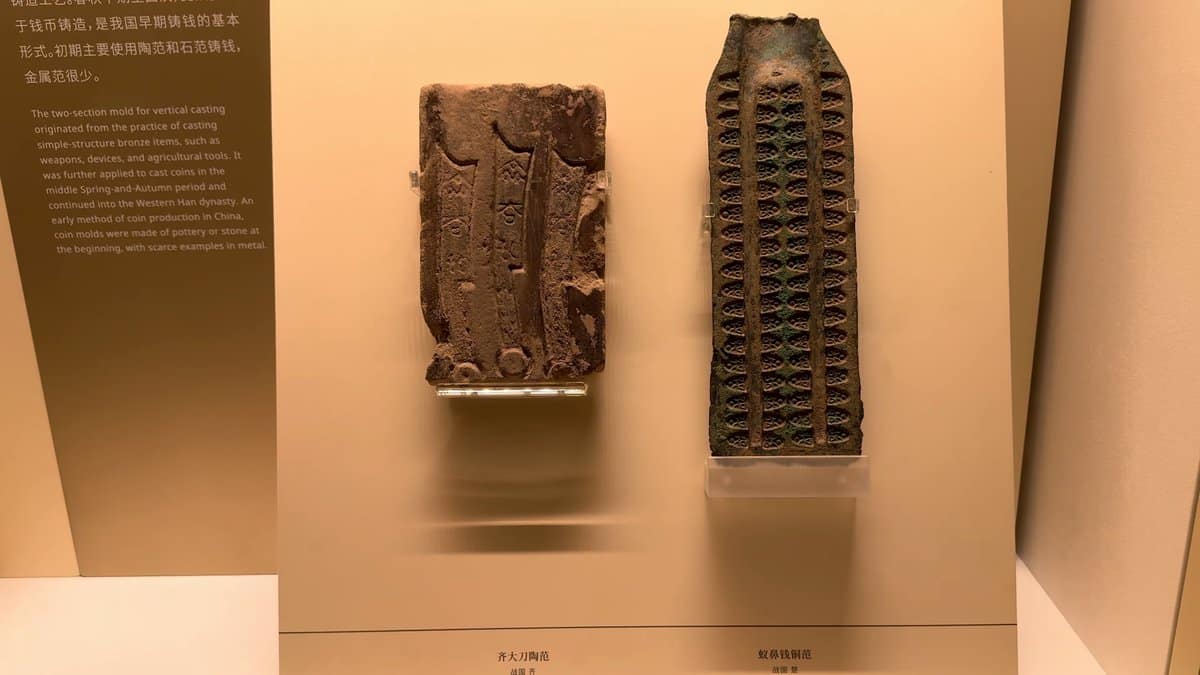 Bronze coin moulds with rows of casting cavities.