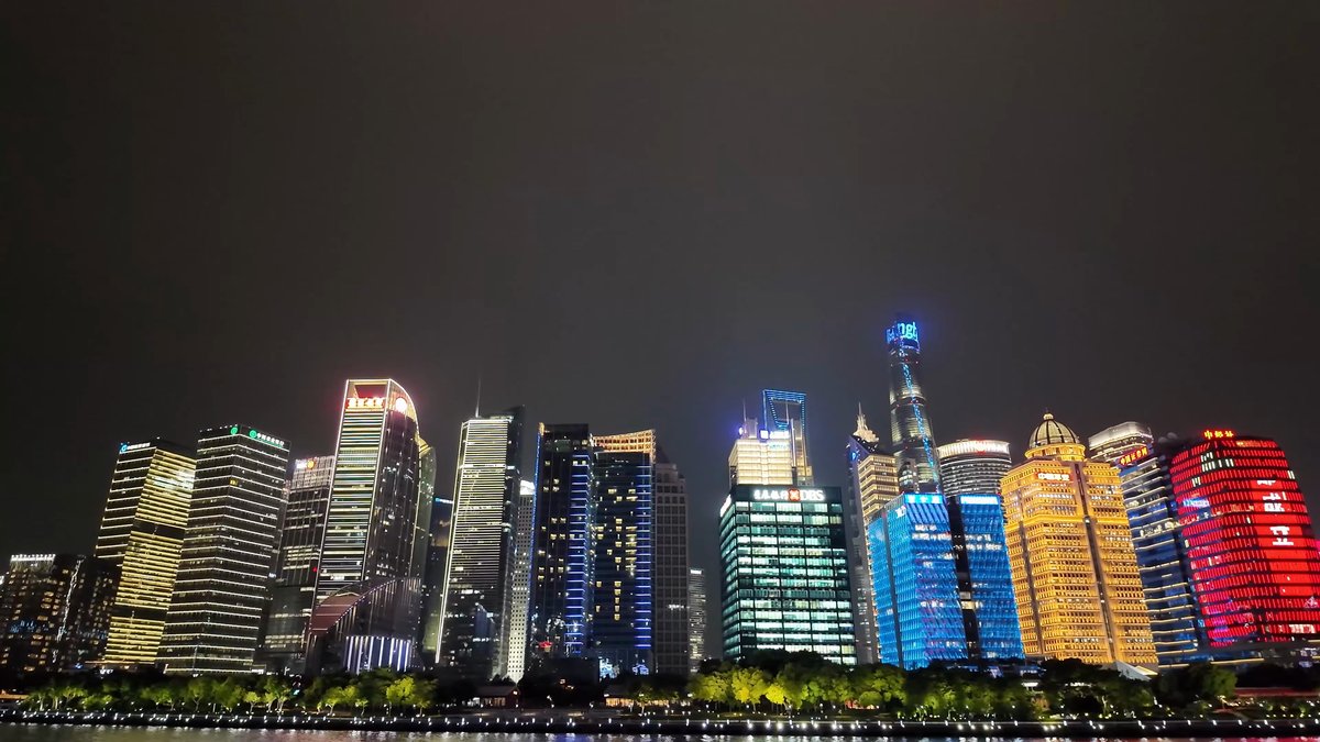 Colourful Lujiazui towers from river
