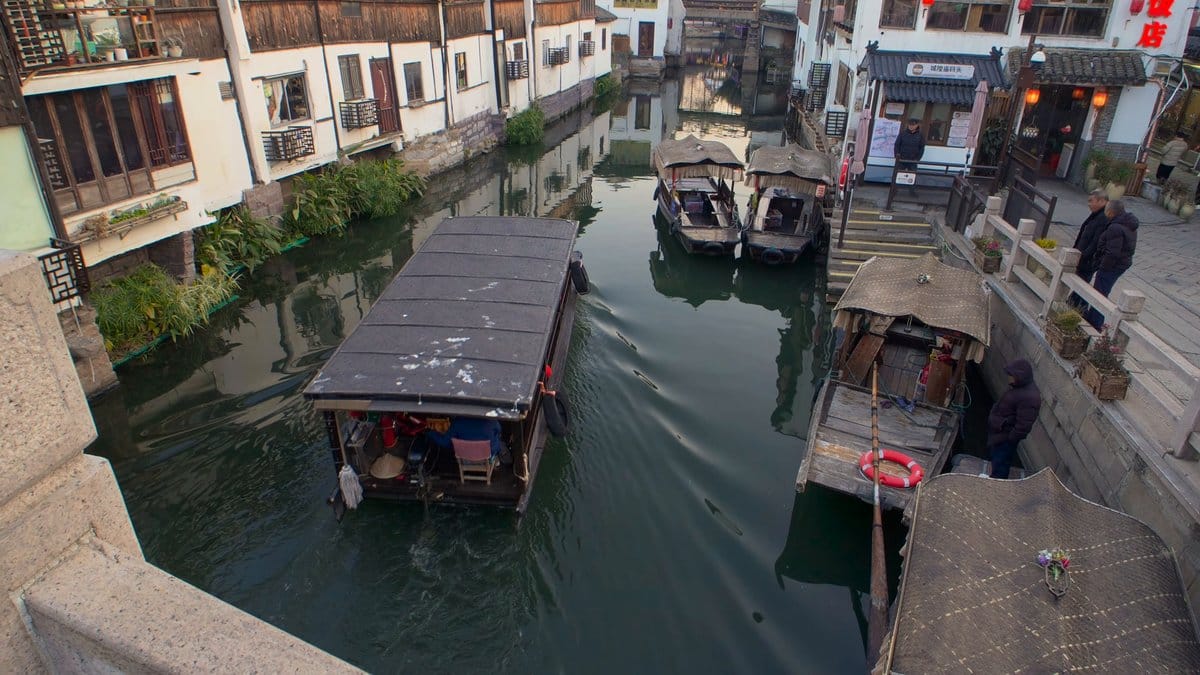 Covered boat moving down canal