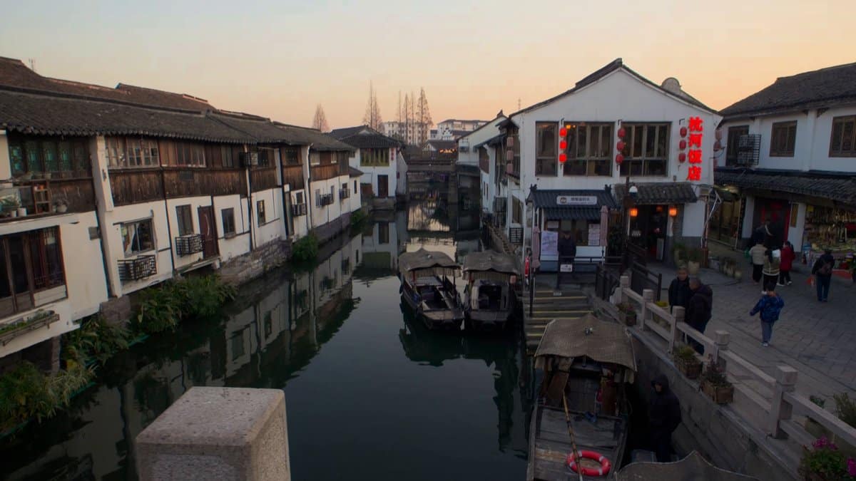 Covered boats moored along canal