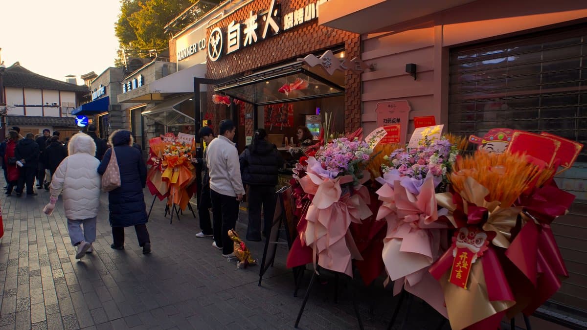 Crowded lane with flower stall