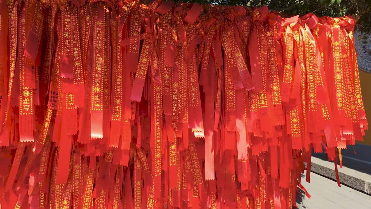 Curtain of gold-printed prayer ribbons