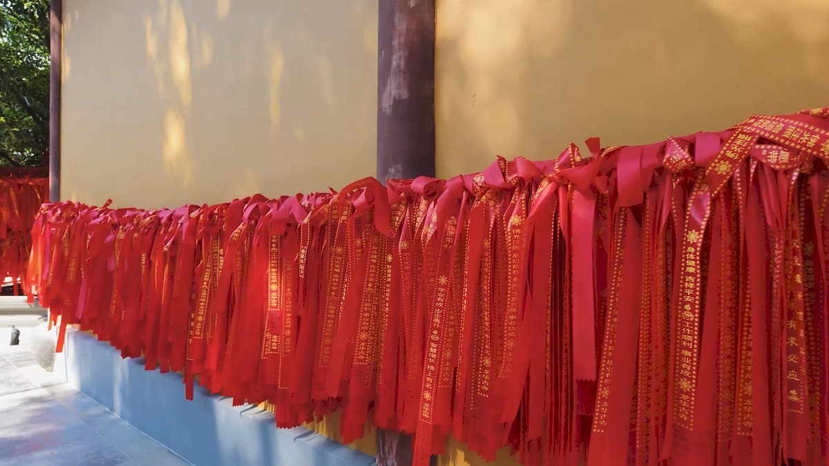 Dense rows of red prayer ribbons