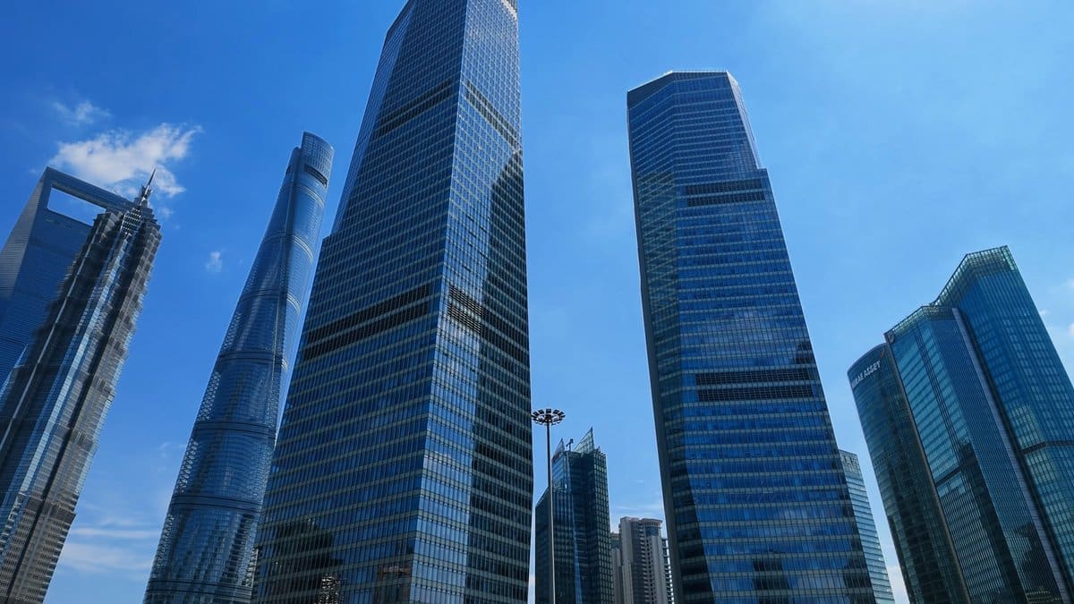 Glass towers reflecting summer sky