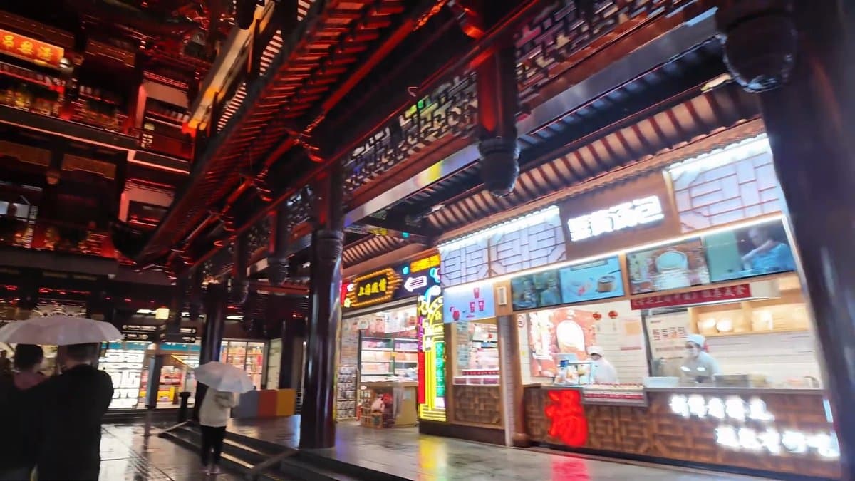 Lit snack kiosk and shopfronts