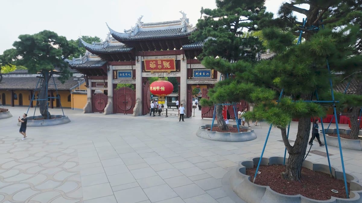 Ornate gateway framed by pines