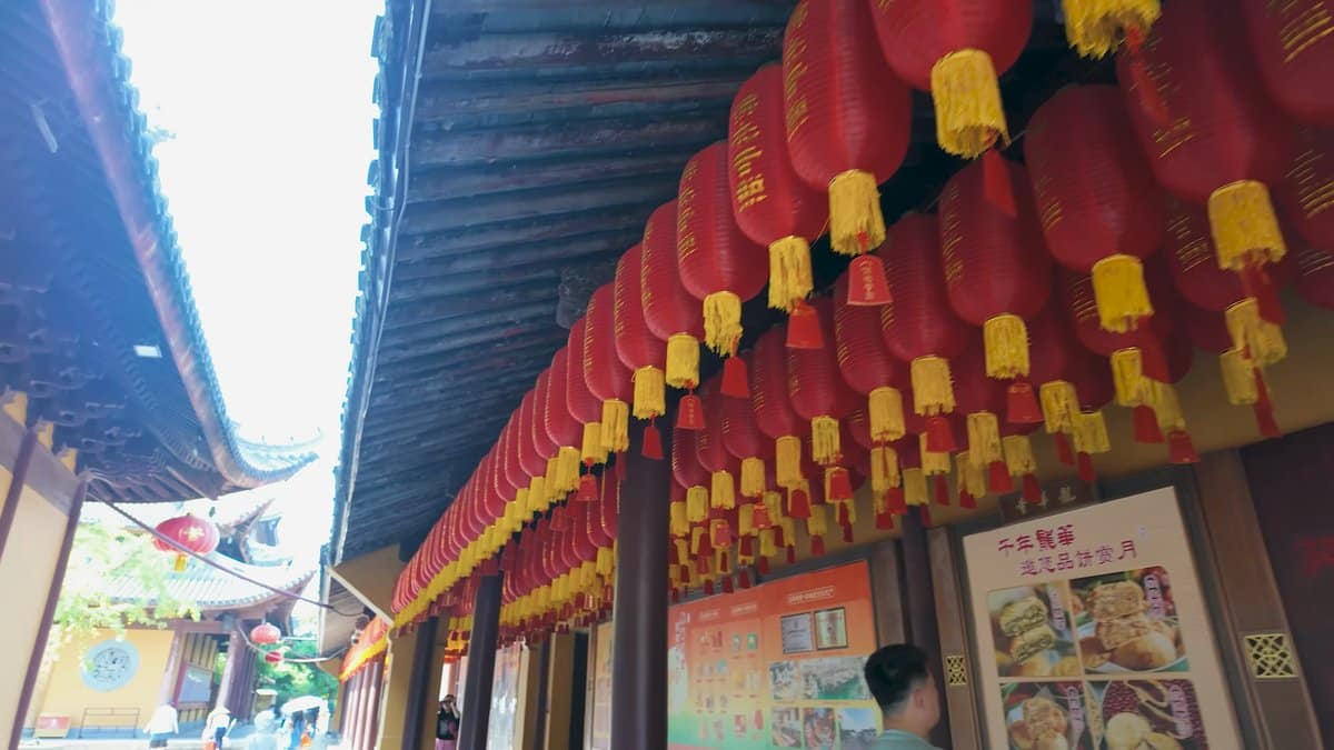 Red lanterns hanging under temple eaves