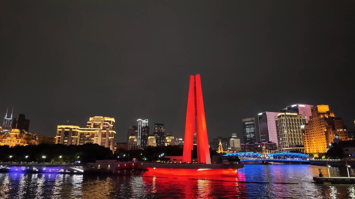 Red monument and lit bridge