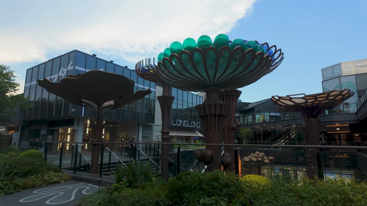 Sculptural green mushroom-shaped canopies in the plaza of