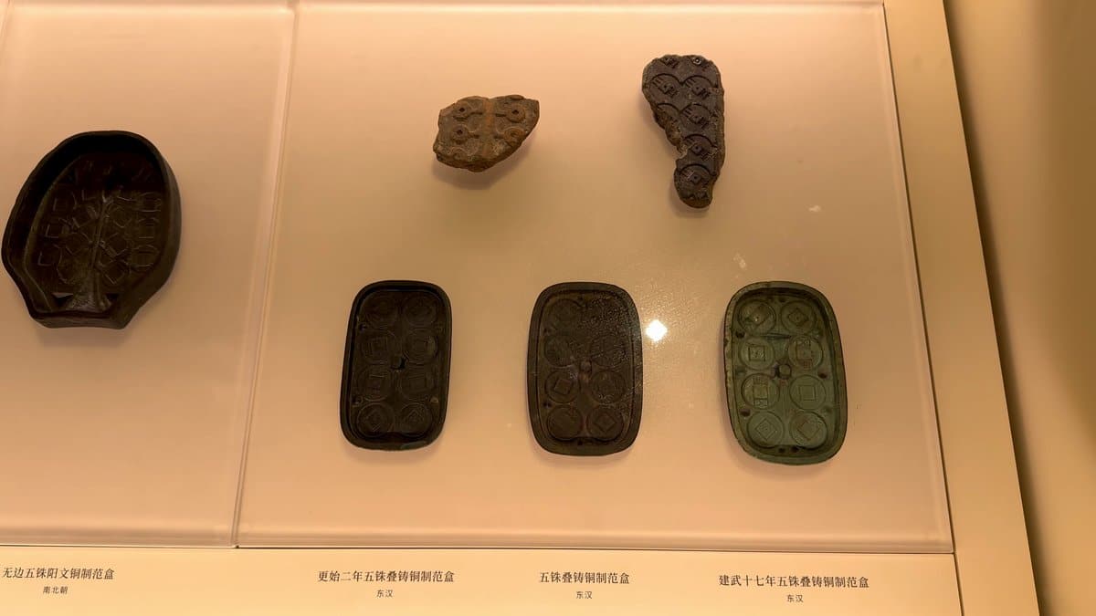 Silver ingots of different shapes in a case.