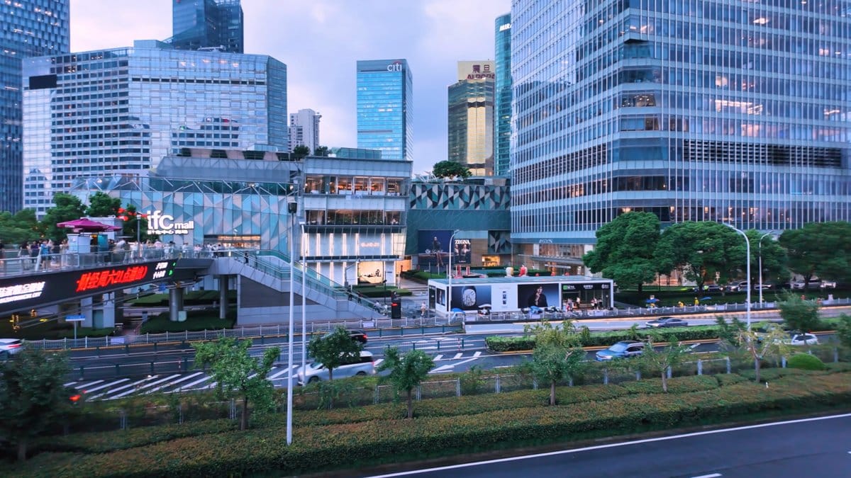 The bridge meeting a mall frontage, low buildings