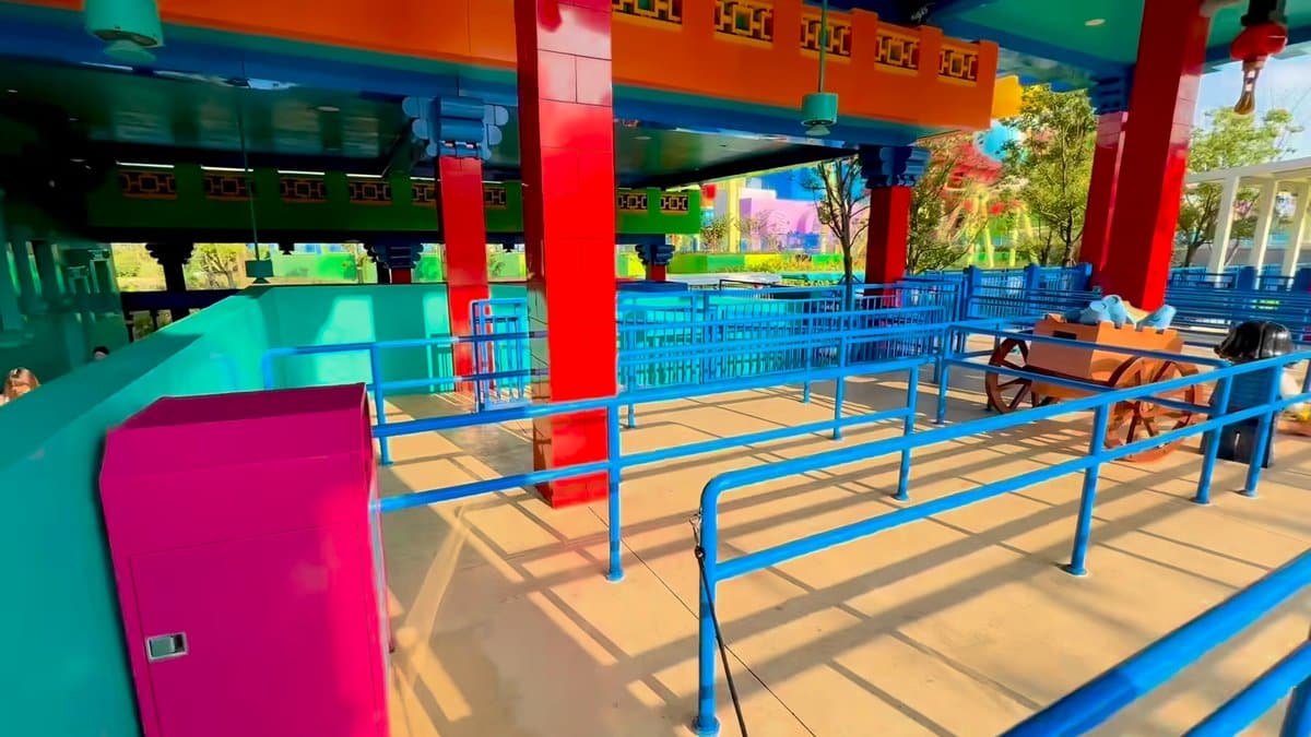 The covered queue area with blue railings and