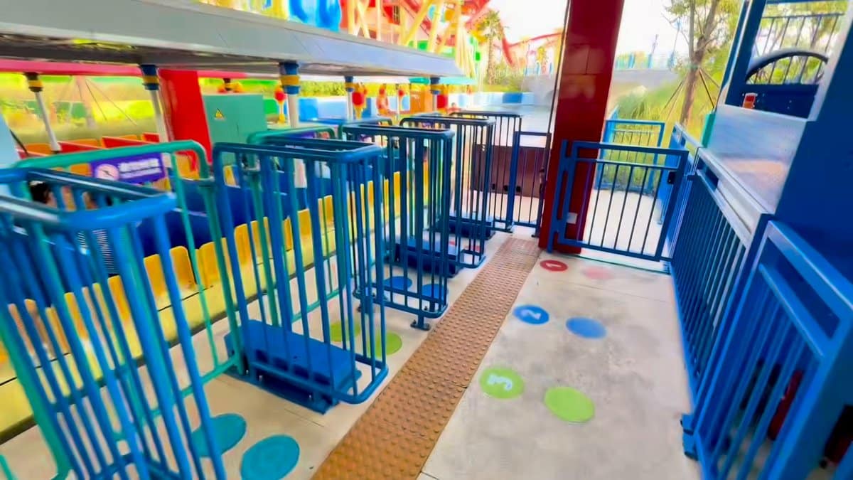 The loading ramp between blue railings, numbered markers