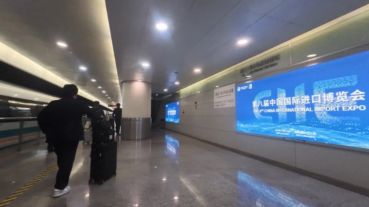 The long corridor lined with a lit billboard