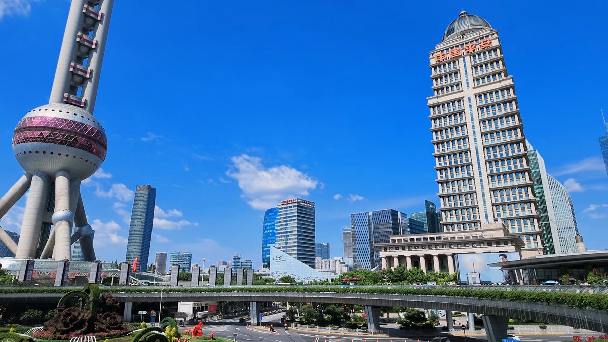 The Oriental Pearl's base beside a stepped tower,