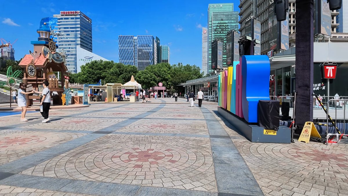 The plaza with a themed display and bright