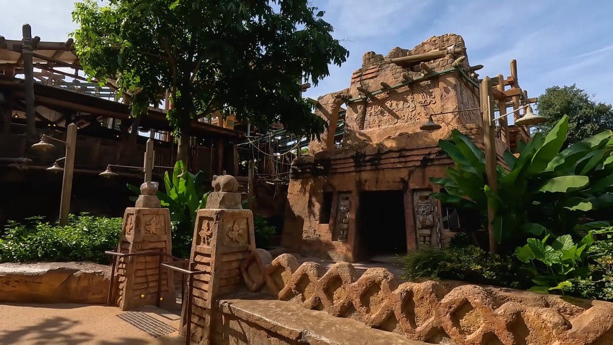 Timber buildings with carved stone posts along the