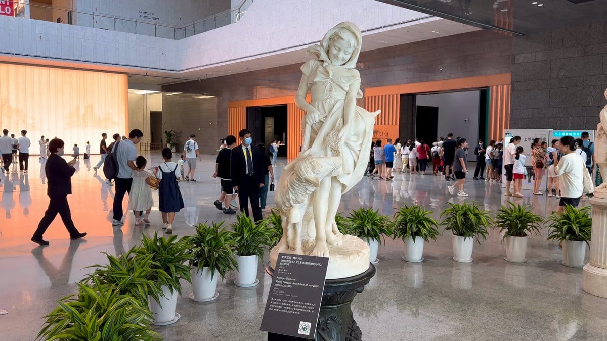 White draped sculpture on plinth